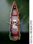 a boat trip for a guy and a girl along the canals and bays of the river overgrown with wild willows. Стоковое фото, агентство Ingram Publishing / Фотобанк Лори
