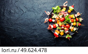 Buffet appetizer of shrimps, jamon, fruits and vegetables.Fresh summer fruit snacks on bamboo skewers. snack from vegetables, fruits, meat and seafood. Стоковое фото, агентство Ingram Publishing / Фотобанк Лори
