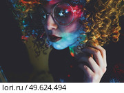 Young woman portrait illuminated by psychedelic lights. Стоковое фото, агентство Ingram Publishing / Фотобанк Лори