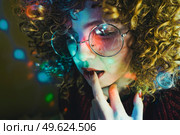 Young woman portrait illuminated by psychedelic lights. Стоковое фото, агентство Ingram Publishing / Фотобанк Лори