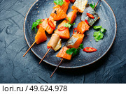 Kebabs from dried and salmon on wooden skewers.Delicious smoked fish. Dried fish salmon. Стоковое фото, агентство Ingram Publishing / Фотобанк Лори