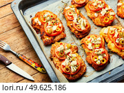Thin layer of meat, breaded in breadcrumbs with cheese, olives and tomato. Meat dish - schnitzel. Meat schnitzel with cheese, olives and tomato. Стоковое фото, агентство Ingram Publishing / Фотобанк Лори