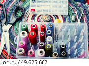 Multicolor threads, needles, buttons and seamstress instrument. Sewing accessories. A set of accessories for needlework. Стоковое фото, агентство Ingram Publishing / Фотобанк Лори