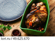 Delicious roast pork knuckle in the baking dish. Roast pork knuckle, pork hock. Стоковое фото, агентство Ingram Publishing / Фотобанк Лори