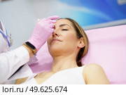 Aesthetic doctor painting on the face of his middle-aged patient the areas to be treated with botulinum toxin.. Aesthetic doctor painting on the face of his patient the areas to be treated with botulinum toxin. Стоковое фото, агентство Ingram Publishing / Фотобанк Лори