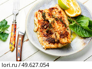 Tasty baked fish, fried pike perch in orange sauce.. Roasted fish fillets. Стоковое фото, агентство Ingram Publishing / Фотобанк Лори
