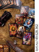 typical Tarot spelling  cards set up  by  with gemstones. hobby and life style concept. Редакционное фото, агентство Ingram Publishing / Фотобанк Лори