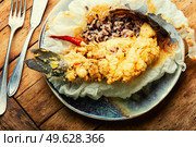 Deep fried sea bass fish with rice on rice paper. Roasted seafood. Tasty fried sea bass fish. Стоковое фото, агентство Ingram Publishing / Фотобанк Лори