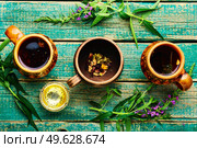 Cup of herbal tea on the table. Ivan tea or fireweed.Herbal medicine. fireweed tea,rustic wooden table. Стоковое фото, агентство Ingram Publishing / Фотобанк Лори