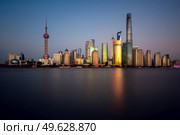 Shanghai - November 15, 2019 : Lujiazui skyline, as seen from the Bund, across the Huangpu River, the tallest building being Shanghai Tower. The Lujiazui district is the commercial and financial center of Shanghai.. Lujiazui skyline and Huangpu river, Shanghai, China. Редакционное фото, агентство Ingram Publishing / Фотобанк Лори