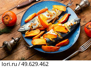 Seafood, roasted mackerel. Fish scomber in persimmon fruit.. Grilled mackerel fish with persimmon. Стоковое фото, агентство Ingram Publishing / Фотобанк Лори