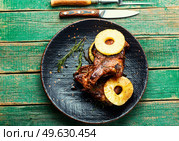 Appetizing beef meat baked with pineapple rings. Beef entricote in fruit marinade.. Meat barbecue with pineapple rings. Стоковое фото, агентство Ingram Publishing / Фотобанк Лори