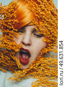 Moody portrait in orange tones of a white woman. Стоковое фото, агентство Ingram Publishing / Фотобанк Лори