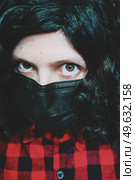 Young woman wearing a black face mask. Стоковое фото, агентство Ingram Publishing / Фотобанк Лори