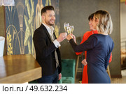 Group of positive well dressed friends clinking glasses with sparkling champagne while celebrating festive event in luxury bar. Happy elegant friends celebrating event in restaurant. Стоковое фото, агентство Ingram Publishing / Фотобанк Лори