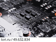 Detailed view of a circuit board featuring intricate pathways and components. Стоковое фото, фотограф EugeneSergeev / Фотобанк Лори