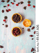  jerked cherry with   dry dog rose and hawthorn,  anise  around blue wooden background . Christmas background. flat lay. Стоковое фото, агентство Ingram Publishing / Фотобанк Лори