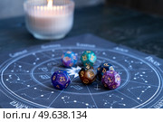 Horoscope zodiac circle with divination dice. Fortune telling and astrology predictions concept, magic rituals and exoteric experience. Zodiac horoscope with divination dice. Стоковое фото, агентство Ingram Publishing / Фотобанк Лори