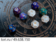 Horoscope zodiac circle with divination dice. Fortune telling and astrology predictions concept, magic rituals and exoteric experience. Zodiac horoscope with divination dice. Стоковое фото, агентство Ingram Publishing / Фотобанк Лори