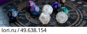 Horoscope zodiac circle with divination dice. Fortune telling and astrology predictions concept, magic rituals and exoteric experience. Zodiac horoscope with divination dice. Стоковое фото, агентство Ingram Publishing / Фотобанк Лори