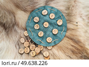 Handmade runes for fortunetelling over green leather chart. Handmade runes for fortunetelling. Стоковое фото, агентство Ingram Publishing / Фотобанк Лори