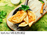 Cheburek, a dish of unleavened dough stuffed with minced meat. Traditional homemade pasties, cheburek. Стоковое фото, агентство Ingram Publishing / Фотобанк Лори