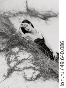 girl in a black long dress in a sandy desert under a blue sky. Стоковое фото, агентство Ingram Publishing / Фотобанк Лори
