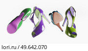 Selection of bright colored flying high heels at white background. Levitation fashion concept with fancy modern shoes in trend color. Fashionable women footwear. Front view. Стоковое фото, агентство Ingram Publishing / Фотобанк Лори