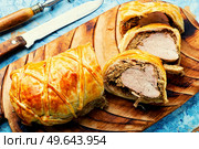 Juicy meat in a dough with spices, mushroom or vegetable pate. Wellington meat.. Wellington meat is a festive tenderloin dish. Стоковое фото, агентство Ingram Publishing / Фотобанк Лори
