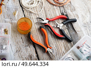 orange set for handmade jewelry  around white old style wooden background. close up. Стоковое фото, агентство Ingram Publishing / Фотобанк Лори