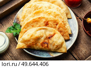 Chebureks, fried crescent-shaped cakes with meat filling. Fried pies. Homemade fried cheburek pies. Стоковое фото, агентство Ingram Publishing / Фотобанк Лори