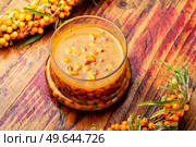 Useful sea buckthorn jam. Homemade berry jam on an rustic wooden table. Autumn sea buckthorn jam. Стоковое фото, агентство Ingram Publishing / Фотобанк Лори