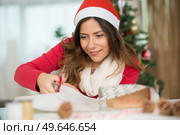 woman wrapping christmas gift box. Стоковое фото, агентство Ingram Publishing / Фотобанк Лори