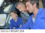 close up of apprentices finding the cockpit defect. Стоковое фото, агентство Ingram Publishing / Фотобанк Лори