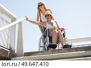 woman on wheelchair before stairs and waiting for help. Стоковое фото, агентство Ingram Publishing / Фотобанк Лори