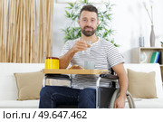 positive delighted invalid man having breakfast. Стоковое фото, агентство Ingram Publishing / Фотобанк Лори