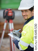 young geometer on a construction site. Стоковое фото, агентство Ingram Publishing / Фотобанк Лори