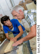 male workers are doing woodworks. Стоковое фото, агентство Ingram Publishing / Фотобанк Лори