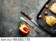 Grilled squids with vegetable stuffing. Stuffed calamari in grill pan. Grilled squid stuffed with vegetables, space for text. Стоковое фото, агентство Ingram Publishing / Фотобанк Лори