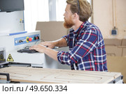 operator cutting wood using special machine. Стоковое фото, агентство Ingram Publishing / Фотобанк Лори
