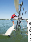 salior trying to right his catamaran after capsize. Стоковое фото, агентство Ingram Publishing / Фотобанк Лори