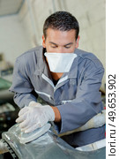 a mechanic is waxing car. Стоковое фото, агентство Ingram Publishing / Фотобанк Лори