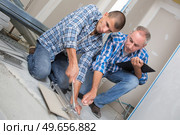 tile cutting worker working with floor tile cutting. Стоковое фото, агентство Ingram Publishing / Фотобанк Лори