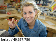 female carpenter working with wood in her workshop. Стоковое фото, агентство Ingram Publishing / Фотобанк Лори