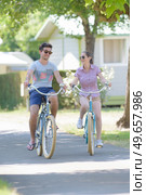 a couple is biking in the campsite. Стоковое фото, агентство Ingram Publishing / Фотобанк Лори