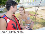 Couple holding rigging of sailing vessel. Стоковое фото, агентство Ingram Publishing / Фотобанк Лори