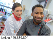 a butcher couple ordering stock. Стоковое фото, агентство Ingram Publishing / Фотобанк Лори