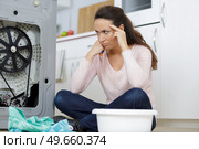 woman looking at leaking sink pipe. Стоковое фото, агентство Ingram Publishing / Фотобанк Лори
