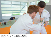 Two men in martial arts combat. Стоковое фото, агентство Ingram Publishing / Фотобанк Лори