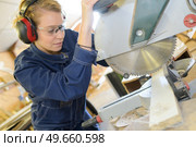 woman with safety goggles ear protection next to circular saw. Стоковое фото, агентство Ingram Publishing / Фотобанк Лори